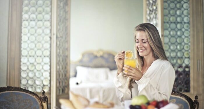 cheerful woman enjoying breakfast in morning