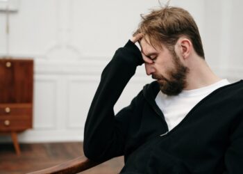 man in black blazer sitting on chair