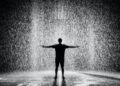 silhouette and grayscale photography of man standing under the rain Send Down The Rain