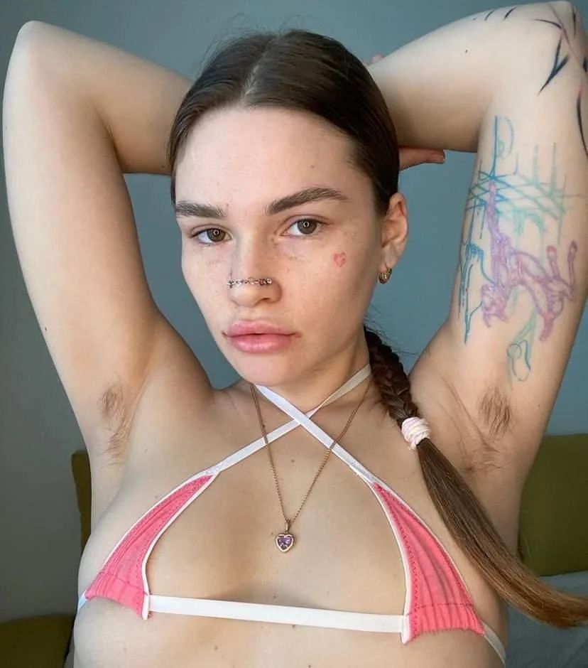 Pink bikini model exposing both of her armpits