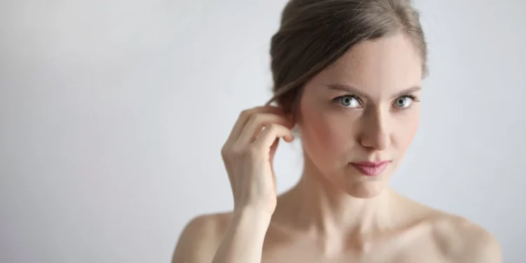 topless woman holding her ears