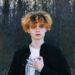 portrait of a boy with curly hair wearing a black shirt