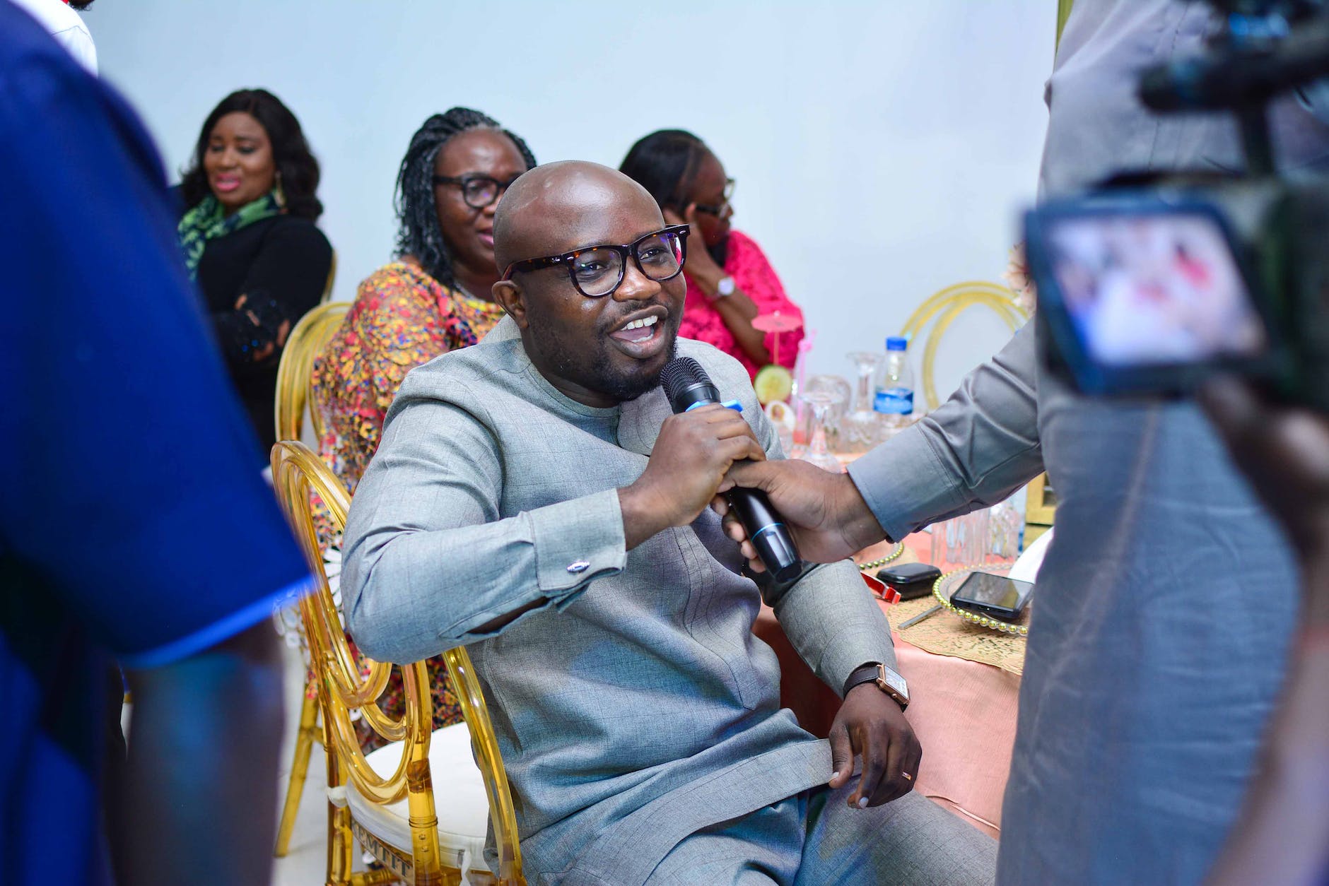 man in gray sweater sitting on chair | Author interviews: Effective strategy to increase book sales