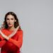 woman in red long sleeve shirt: Feeling the sting of rejection? This candid article explores why "no" isn't final, how to process the pain, and how rejection can actually reshape you into a stronger, truer version of yourself.