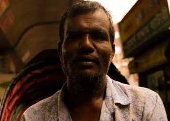 portrait of a man in a shirt on a street market
