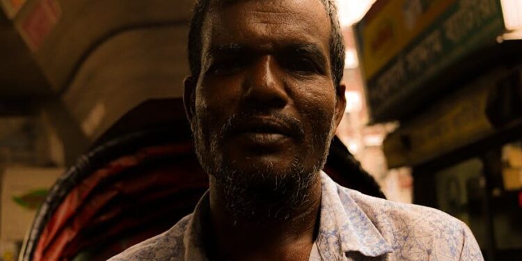 portrait of a man in a shirt on a street market