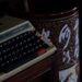vintage typewriter in dimly lit room: As AI tools evolve, many writers are wondering: “Why does this sound like me?” A quiet, honest look at authorship, consent, and creativity.