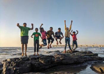 Ignite young minds, inspire innovation, and lead with higher thinking—discover how visionary habits and disruptive ideas shape tomorrow’s industrial and scientific future : boy wearing green crew neck shirt jumping from black stone on seashore
