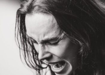 dramatic black and white emotional expression portrait: This essay explores effective anger management techniques and the rising impact of digital disorders. It discusses causes, symptoms, and evidence-based strategies for emotional regulation, along with practical solutions for overcoming smartphone and internet addiction to promote mental well-being.