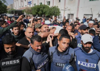 Mourners carry the body of Palestinian journalist Hassan Eslaiah, who was killed in an Israeli strike on Nasser Hospital, with the Israeli military saying he was targeted for being a Hamas terrorist involved in the October 7, 2023, onslaught in southern Israel that sparked the war, in Khan Younis, southern Gaza Strip, May 13, 2025. (AP Photo/Jehad Alshrafi)